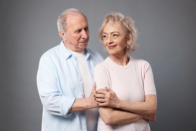 Photo of Portrait of lovely senior couple on grey background