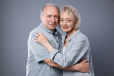 Photo of Portrait of lovely senior couple on grey background