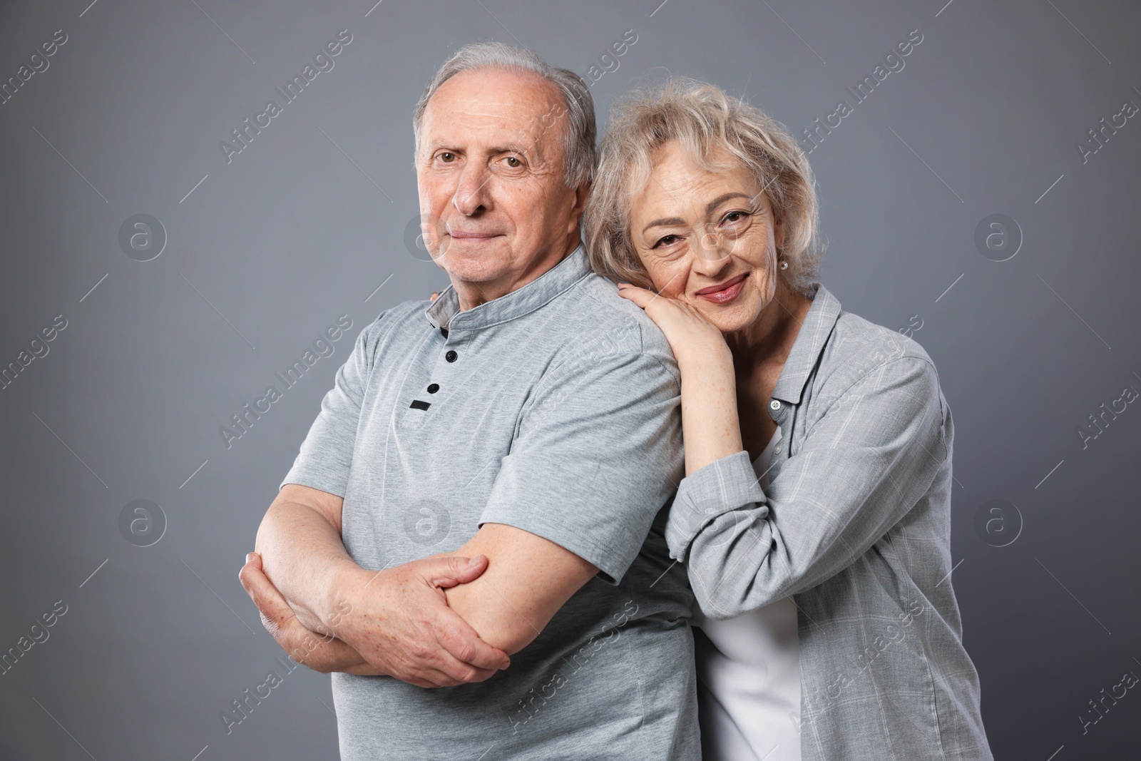 Portrait of lovely senior couple on grey background Photo of Portrait of lovely senior couple on grey background