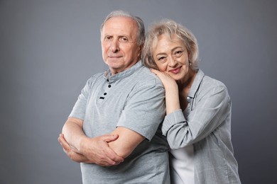 Photo of Portrait of lovely senior couple on grey background
