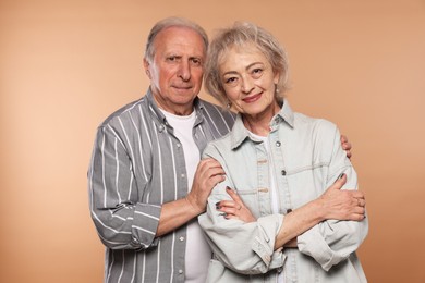 Photo of Portrait of lovely senior couple on beige background