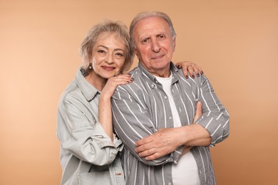 Photo of Portrait of lovely senior couple on beige background