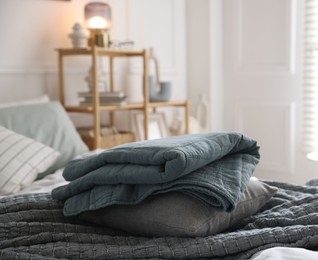 Photo of Fresh linens on bed indoors. Home textile
