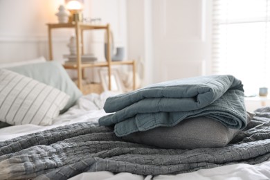 Photo of Fresh linens on bed indoors. Home textile