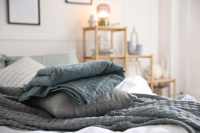 Photo of Fresh linens on bed indoors. Home textile