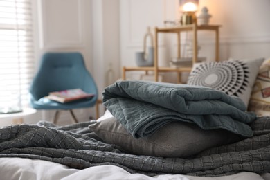 Photo of Fresh linens on bed indoors. Home textile