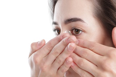 Photo of Woman putting in contact lens on white background, closeup