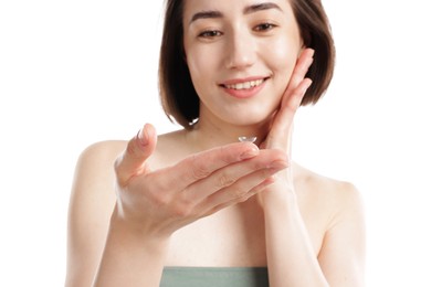 Photo of Woman with contact lens on white background, selective focus