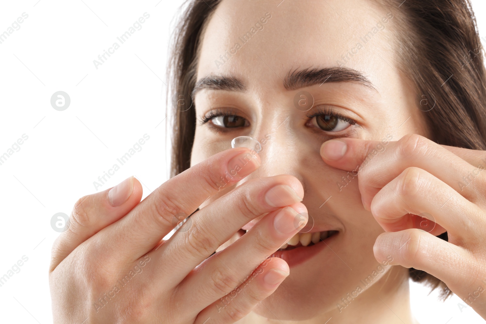 Woman putting in contact lens on white background, closeup Photo of Woman putting in contact lens on white background, closeup