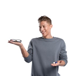 Photo of Man choosing between glasses and contact lenses on white background