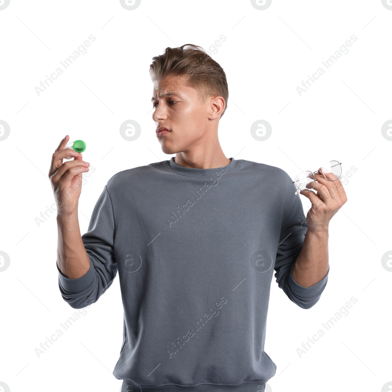 Man choosing between glasses and contact lenses on white background Photo of Man choosing between glasses and contact lenses on white background