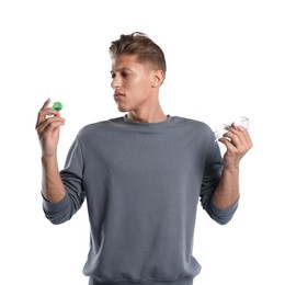 Photo of Man choosing between glasses and contact lenses on white background