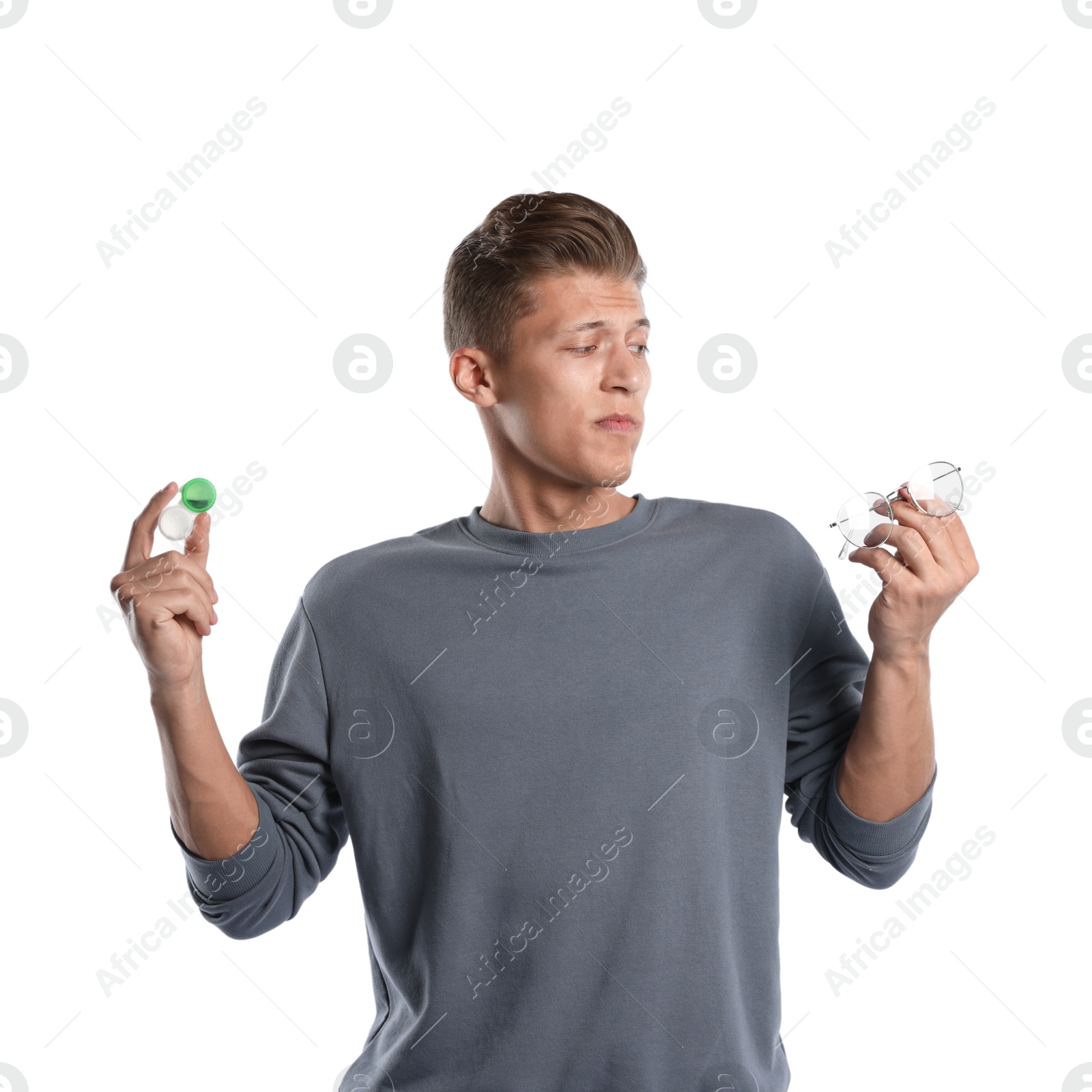 Man choosing between glasses and contact lenses on white background Photo of Man choosing between glasses and contact lenses on white background