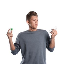 Photo of Man choosing between glasses and contact lenses on white background