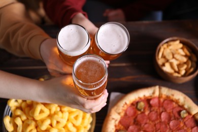 Photo of Friends with beer and snacks at wooden table, top view