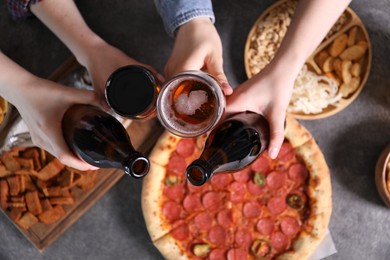 Photo of Friends with beer and snacks at grey table, top view