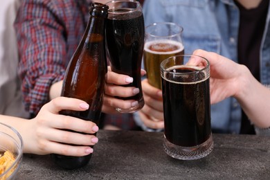 Photo of Friends with beer and snacks at grey table, closeup