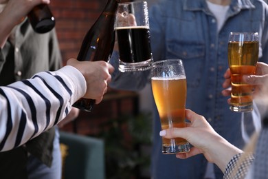 Photo of Friends having refreshing beer at home, closeup