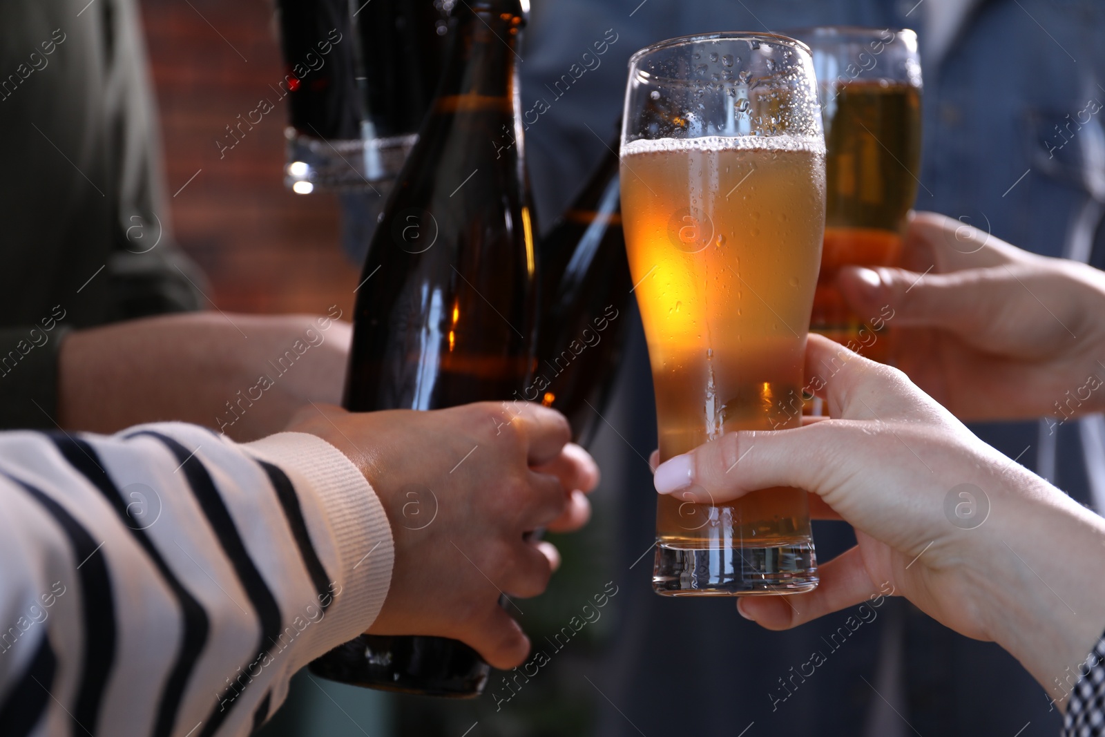 Friends having refreshing beer at home, closeup Photo of Friends having refreshing beer at home, closeup