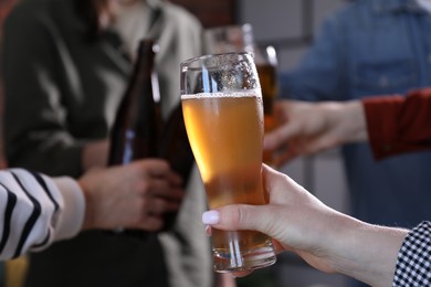 Photo of Friends having refreshing beer at home, closeup