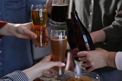 Photo of Friends having refreshing beer at home, closeup