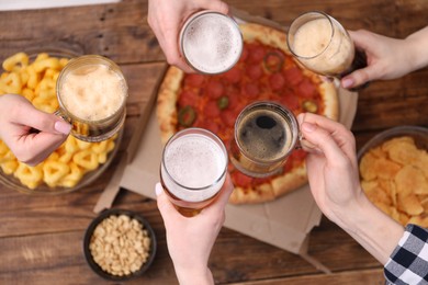 Photo of Friends with beer and snacks at wooden table, top view