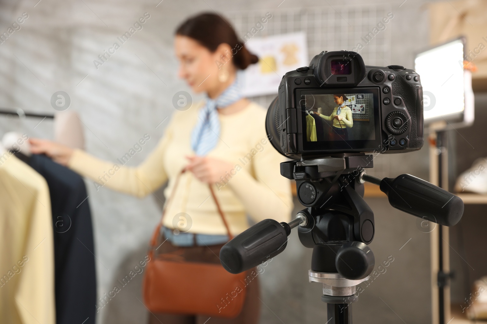 Professional stylist filming video on camera indoors, selective focus Photo of Professional stylist filming video on camera indoors, selective focus