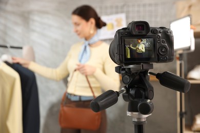 Photo of Professional stylist filming video on camera indoors, selective focus