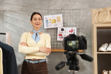 Photo of Professional stylist filming video on camera indoors