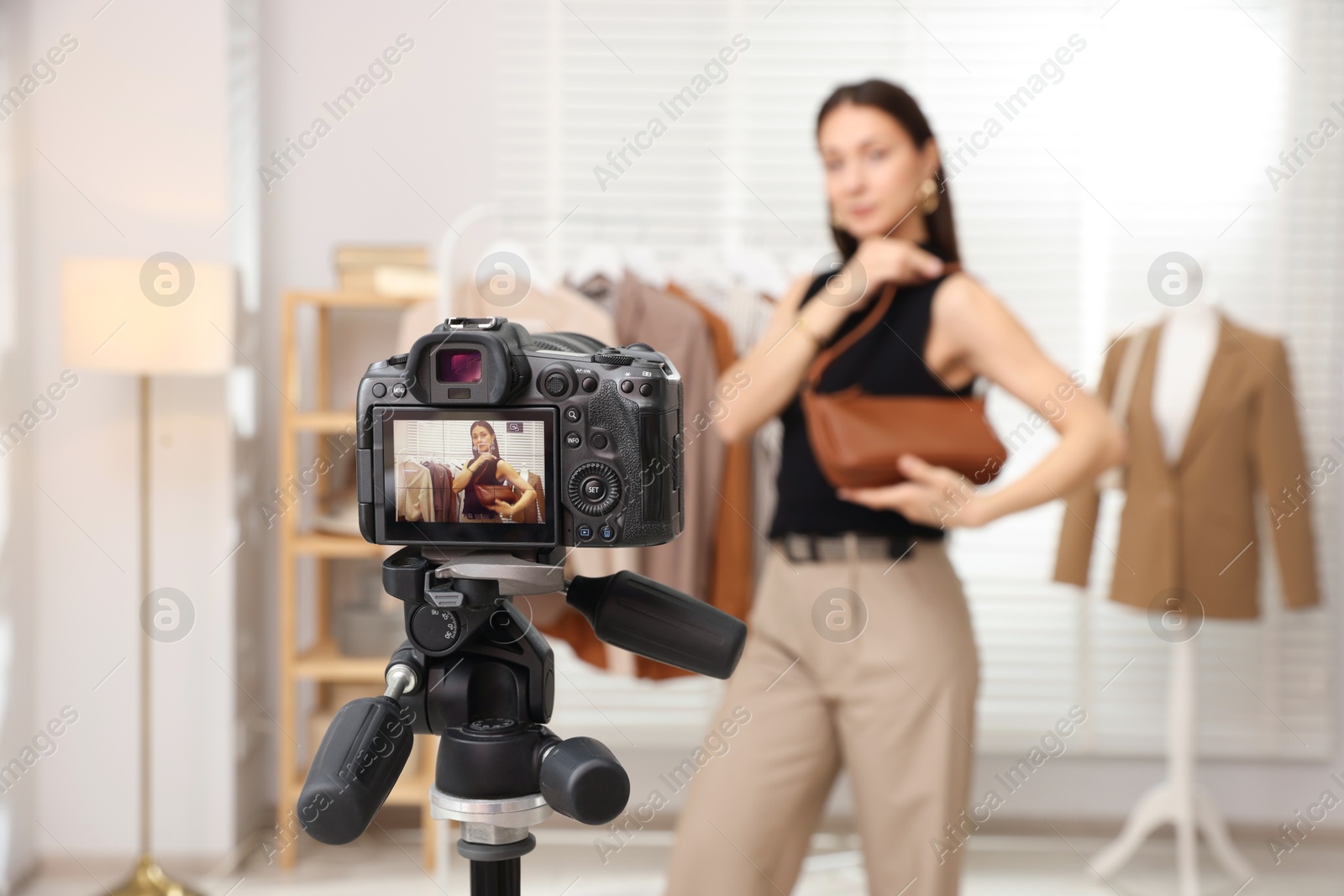 Professional stylist filming video on camera indoors, selective focus Photo of Professional stylist filming video on camera indoors, selective focus