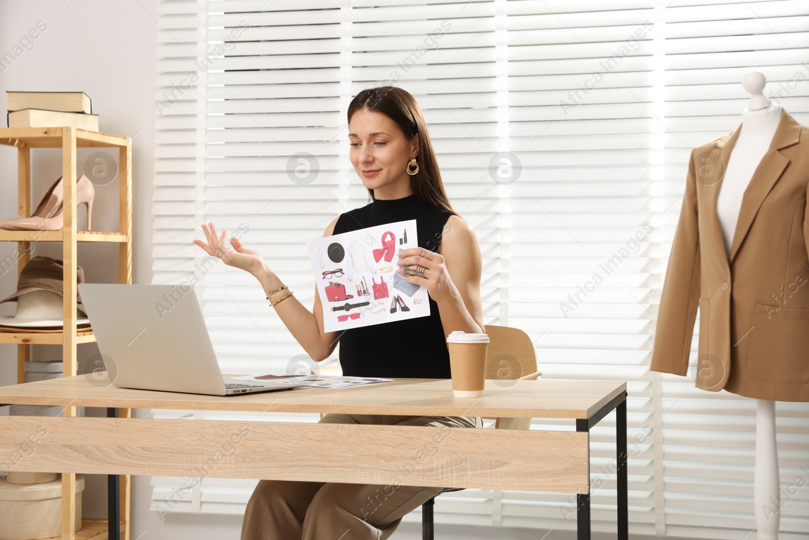 Professional stylist having online consultation with client via laptop at desk indoors Photo of Professional stylist having online consultation with client via laptop at desk indoors