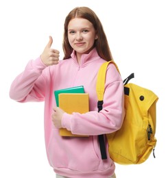 Photo of Teenage girl with books and backpack showing thumbs up on white background