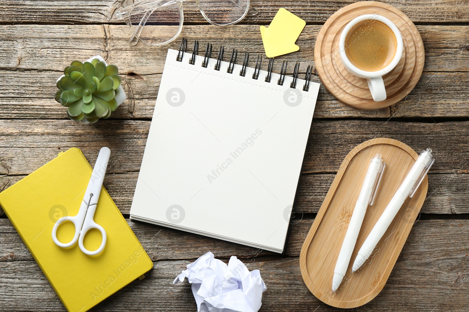 Photo of Flat lay composition with open blank notebook on wooden table