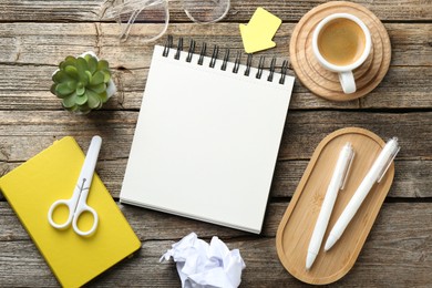 Photo of Flat lay composition with open blank notebook on wooden table