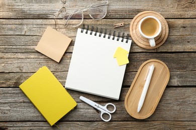 Photo of Flat lay composition with open blank notebook on wooden table