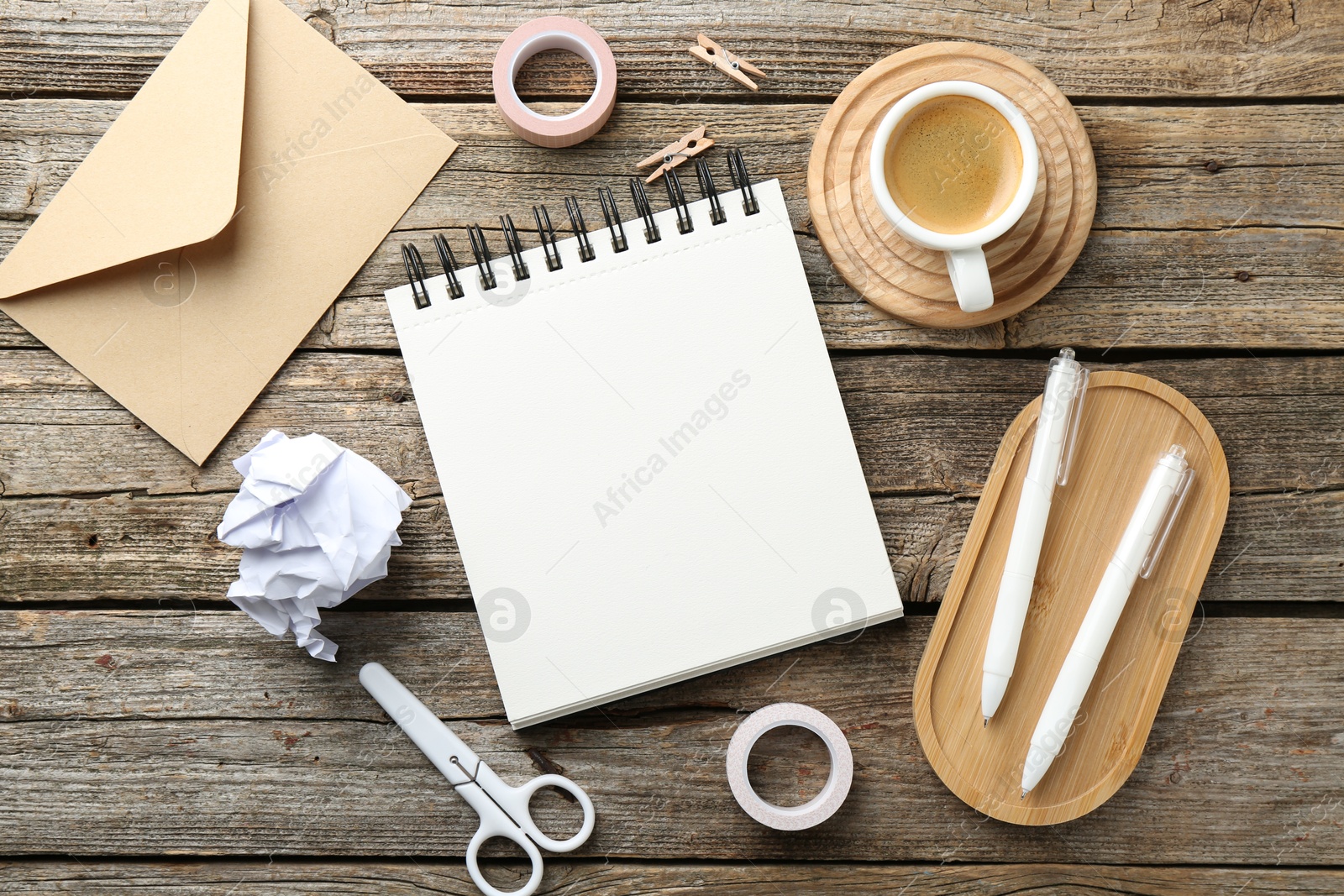 Photo of Flat lay composition with open blank notebook on wooden table