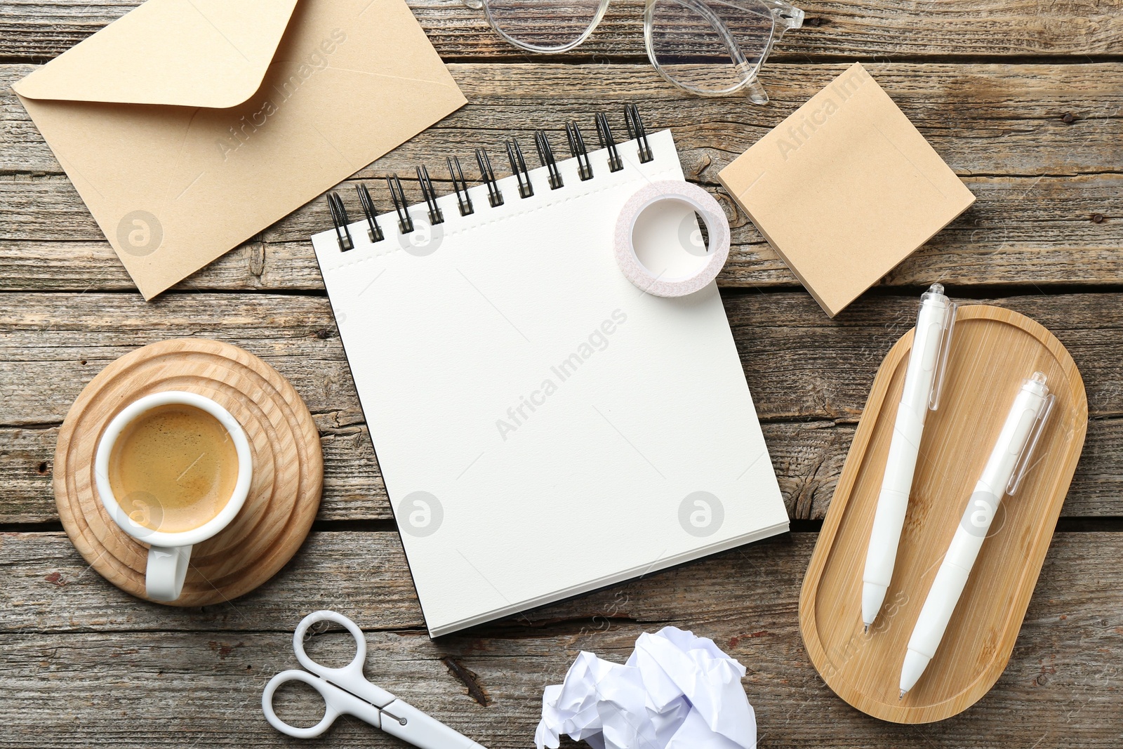 Photo of Flat lay composition with open blank notebook on wooden table
