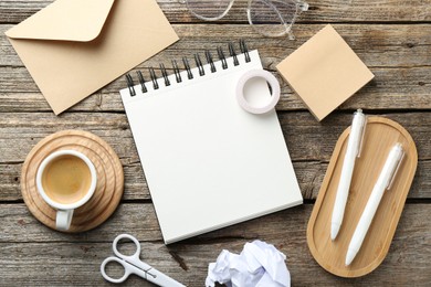 Photo of Flat lay composition with open blank notebook on wooden table