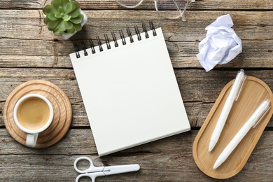 Photo of Flat lay composition with open blank notebook on wooden table