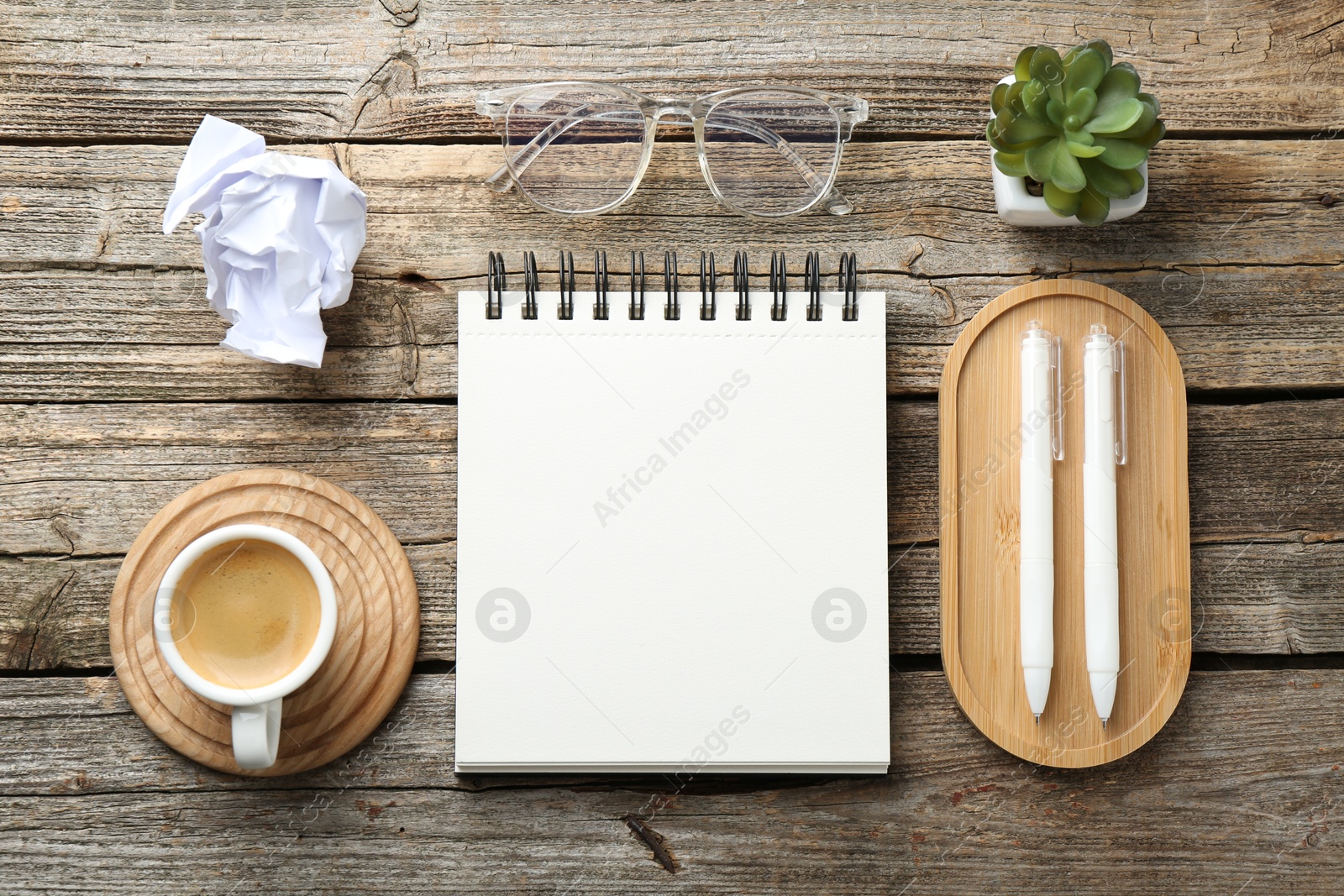 Photo of Flat lay composition with open blank notebook on wooden table