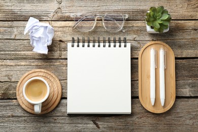Photo of Flat lay composition with open blank notebook on wooden table