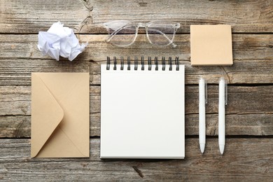 Photo of Flat lay composition with open blank notebook on wooden table
