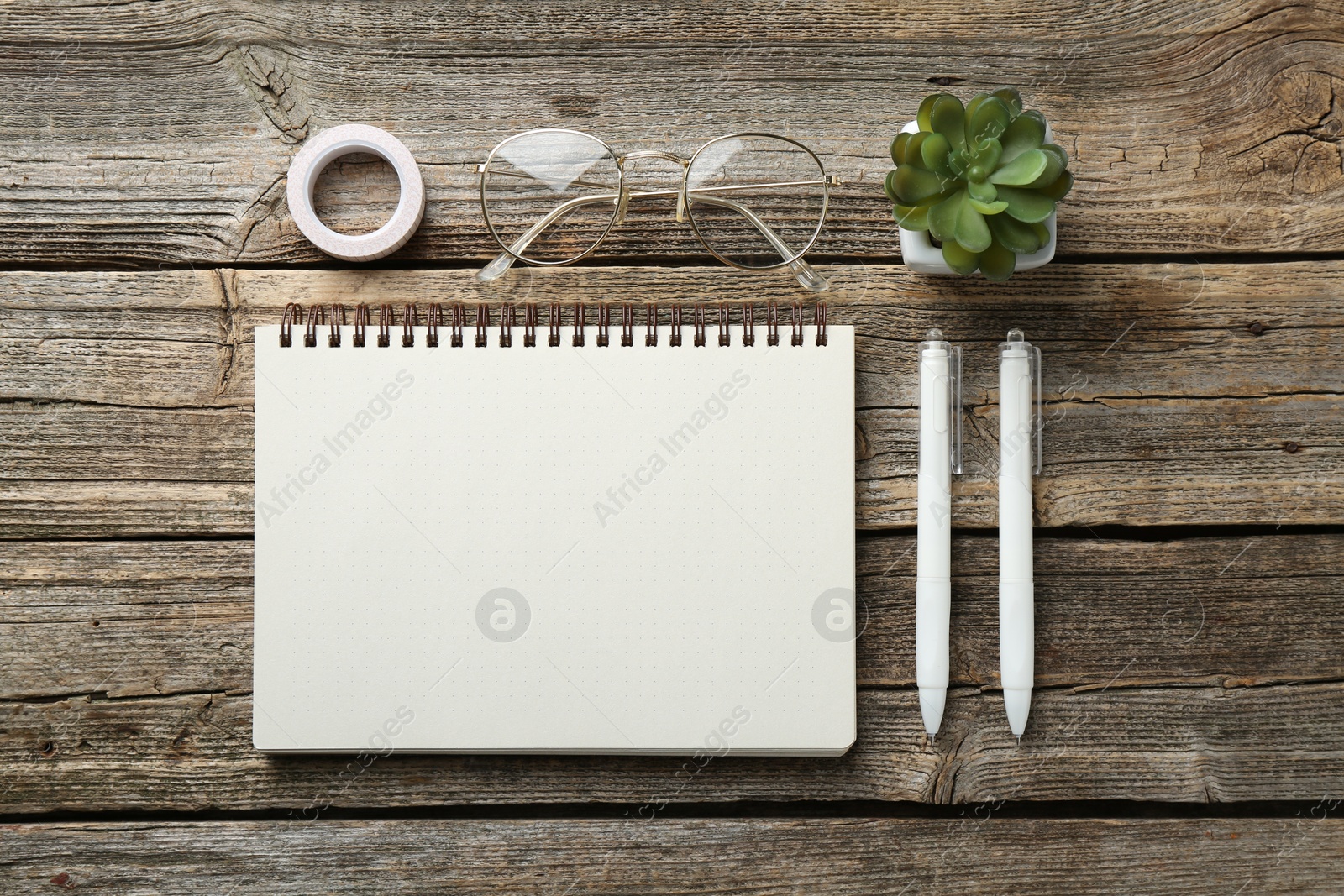 Photo of Flat lay composition with open blank notebook on wooden table