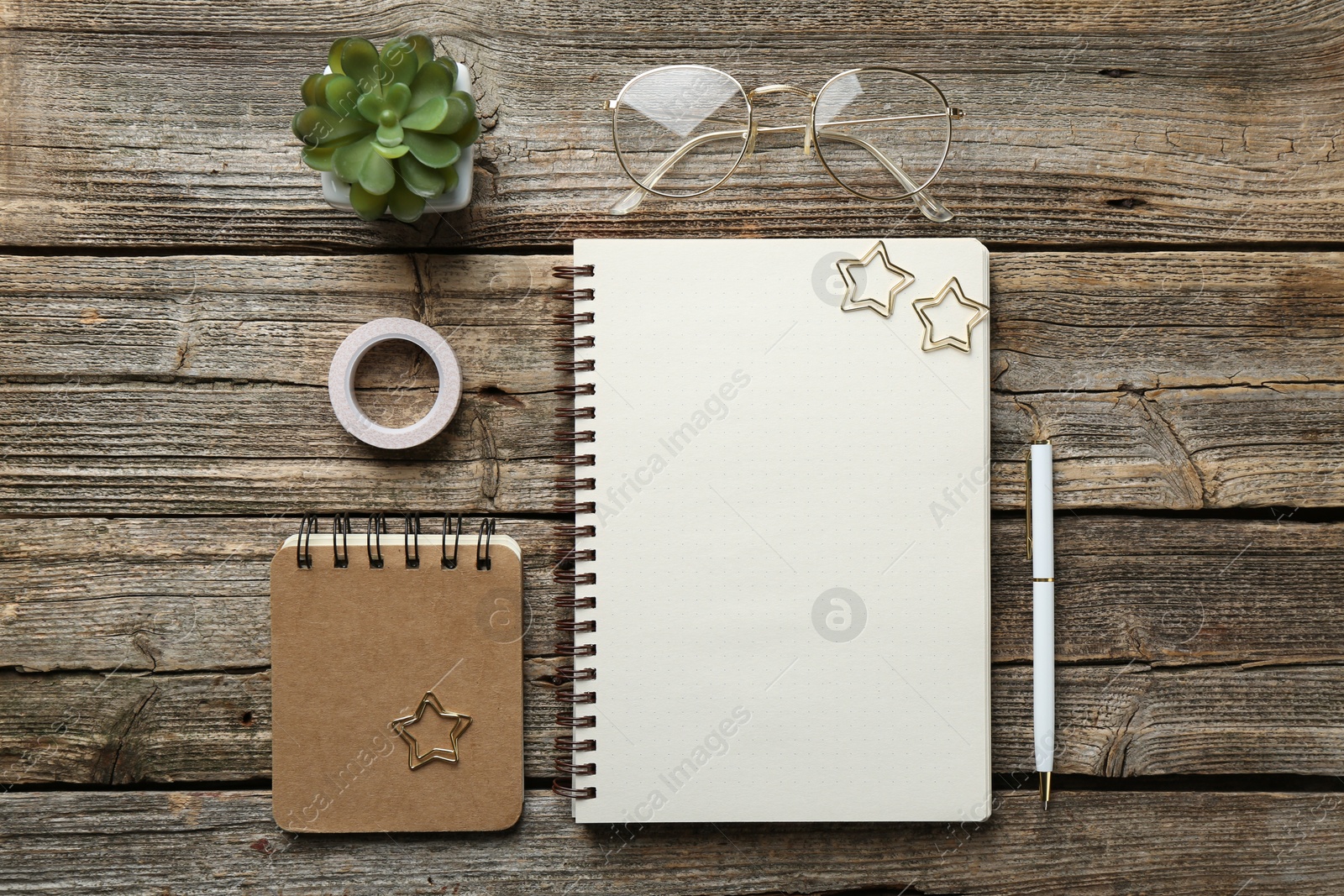 Photo of Flat lay composition with open blank notebook on wooden table