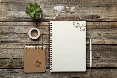 Photo of Flat lay composition with open blank notebook on wooden table