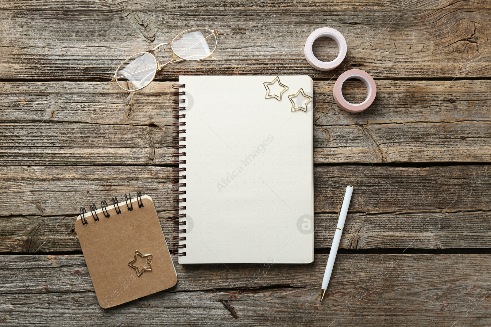 Photo of Flat lay composition with open blank notebook on wooden table