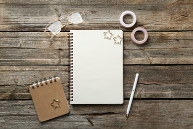 Photo of Flat lay composition with open blank notebook on wooden table