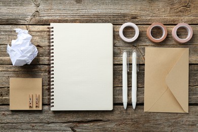 Photo of Flat lay composition with open blank notebook on wooden table