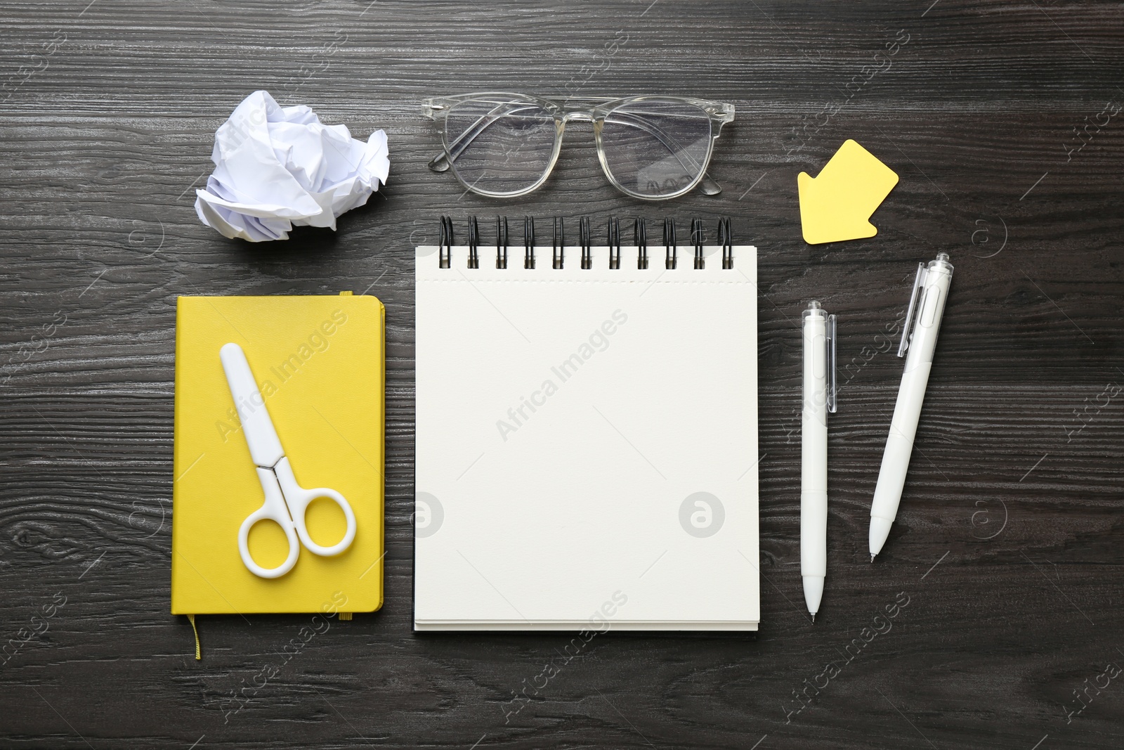 Photo of Flat lay composition with open blank notebook on black wooden table