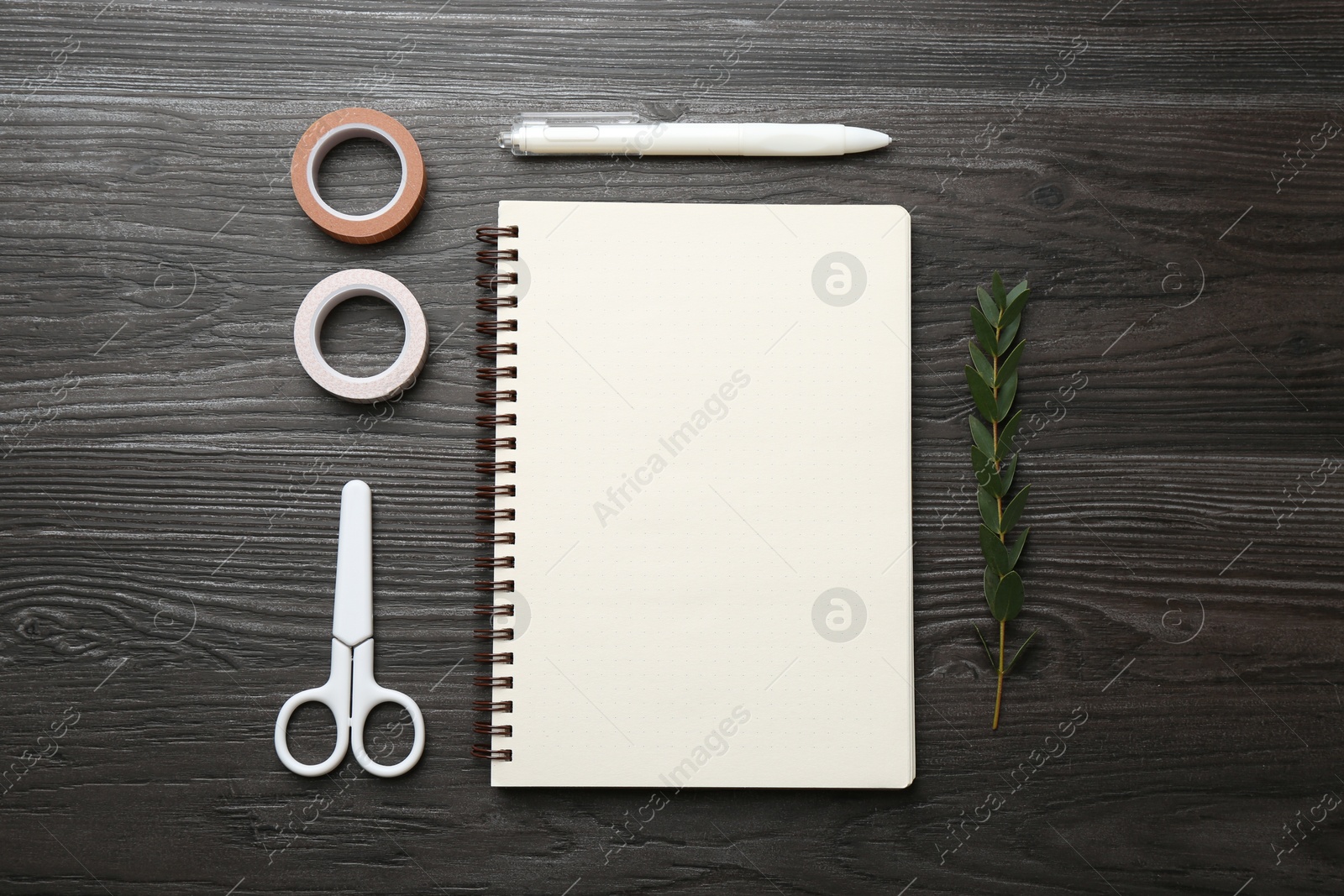 Photo of Flat lay composition with open blank notebook on black wooden table